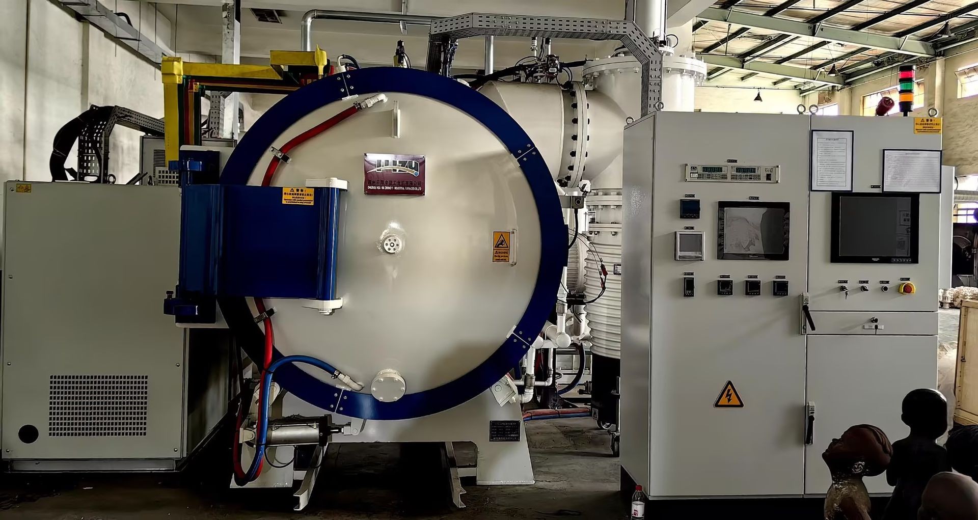 Large industrial machine with control panel, gauges, and wiring in a factory setting.