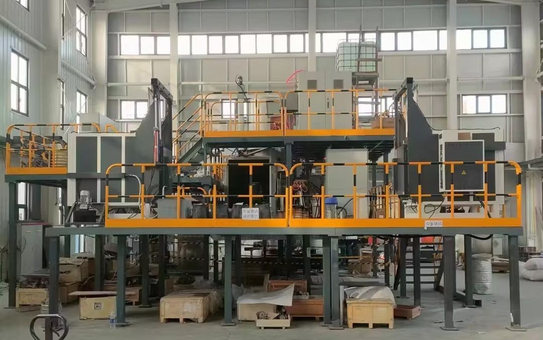 Large industrial machinery setup with multiple platforms and safety railings inside a spacious facility.